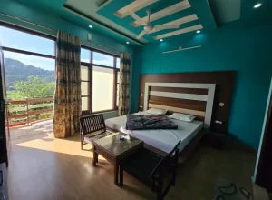 Deluxe room at JK Imperial Hotel Dalhousie with comfortable bed and mountain view